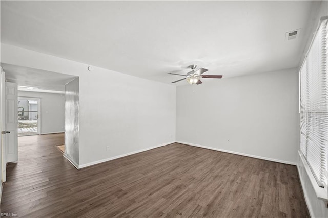 spare room featuring dark wood-type flooring and ceiling fan