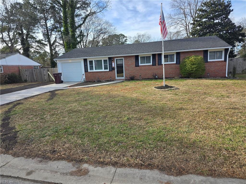 single story home featuring a garage and a front yard