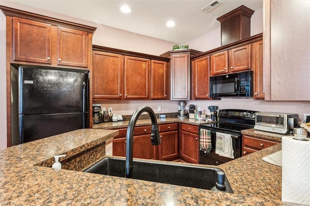 kitchen with sink, black appliances, and light stone countertops