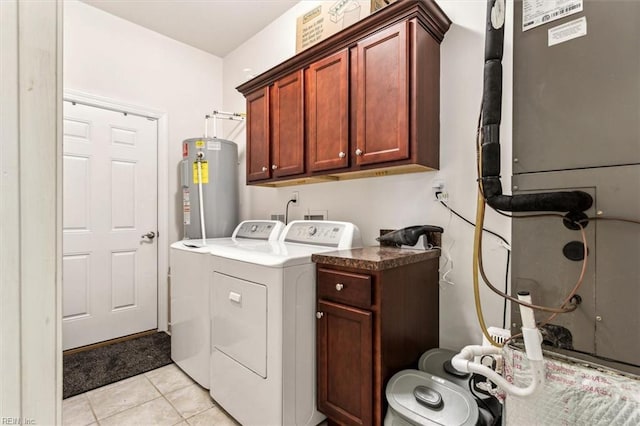 clothes washing area featuring cabinets, light tile patterned floors, washer and clothes dryer, and electric water heater