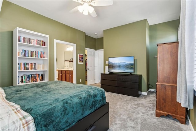 carpeted bedroom featuring ceiling fan and ensuite bath