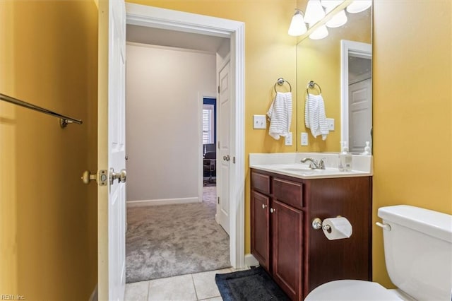 bathroom featuring vanity, tile patterned flooring, and toilet