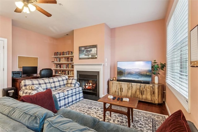 living room with ceiling fan and dark hardwood / wood-style floors