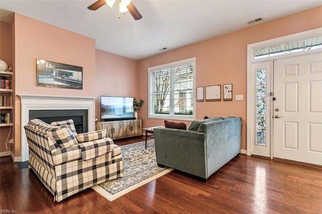 living room with dark hardwood / wood-style floors and ceiling fan