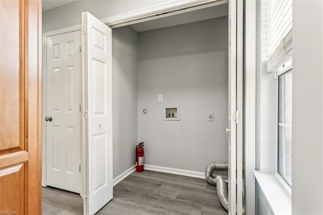 laundry room featuring electric dryer hookup, hookup for a washing machine, and hardwood / wood-style flooring