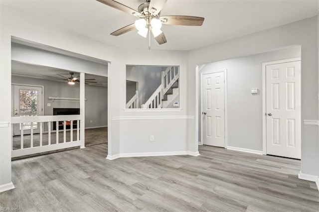 unfurnished room featuring ceiling fan and light hardwood / wood-style floors