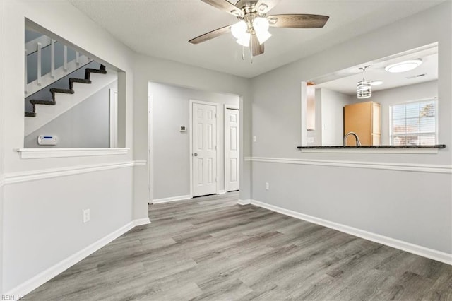 interior space with ceiling fan and hardwood / wood-style floors