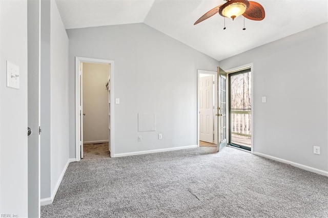 spare room with vaulted ceiling, carpet flooring, and ceiling fan