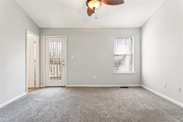 empty room with carpet flooring and ceiling fan