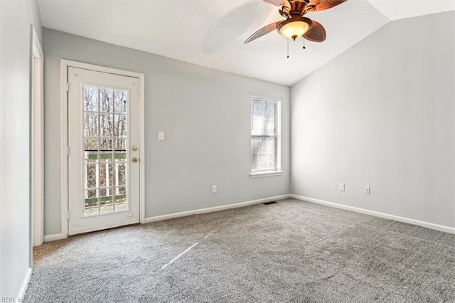 carpeted spare room with vaulted ceiling and ceiling fan