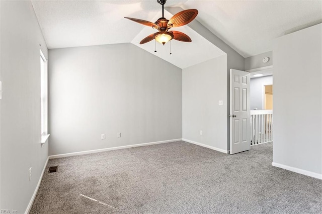 spare room with carpet, lofted ceiling, and ceiling fan