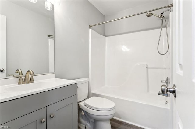 full bathroom with vanity, wood-type flooring, shower / washtub combination, and toilet