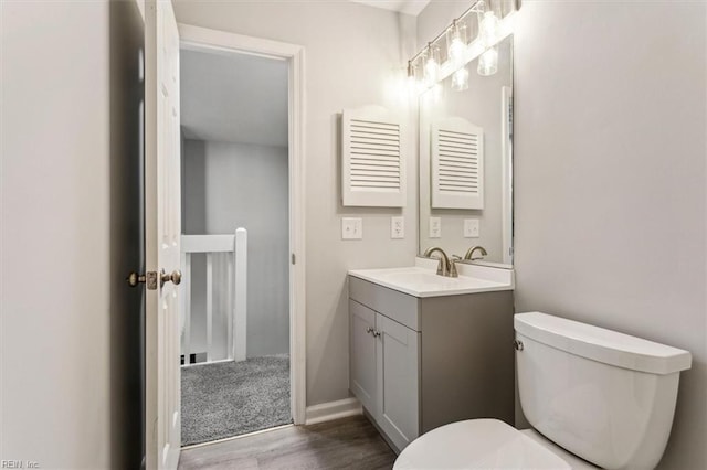 bathroom featuring vanity, toilet, and hardwood / wood-style floors