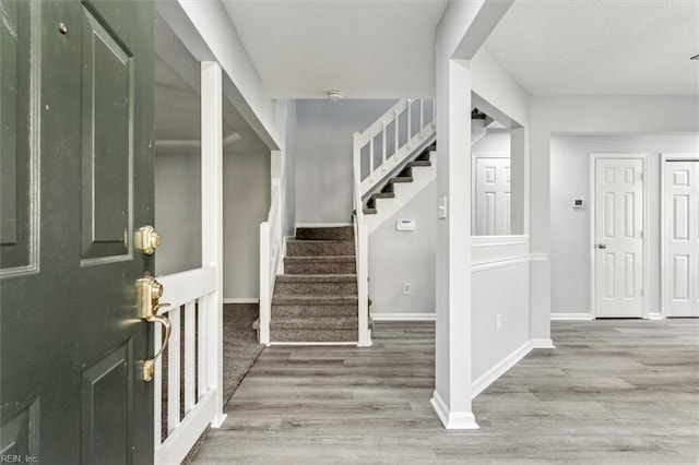 foyer entrance with hardwood / wood-style flooring