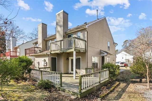 rear view of house with a balcony and a deck