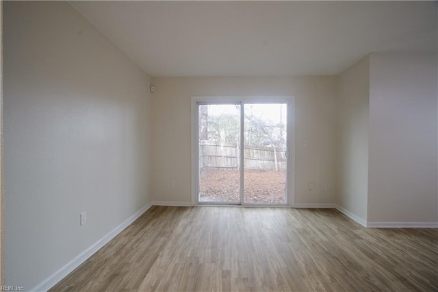 empty room with light hardwood / wood-style flooring