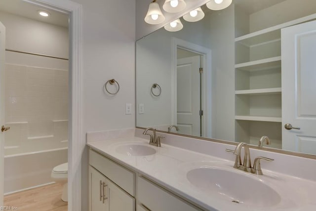 bathroom featuring vanity, wood-type flooring, and toilet