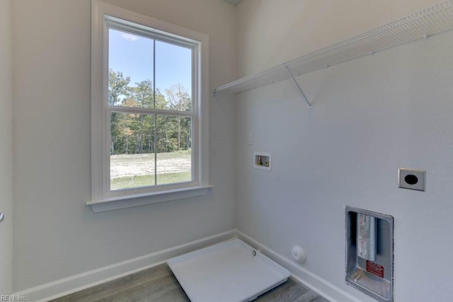 laundry room with gas dryer hookup, hookup for an electric dryer, hookup for a washing machine, and hardwood / wood-style floors