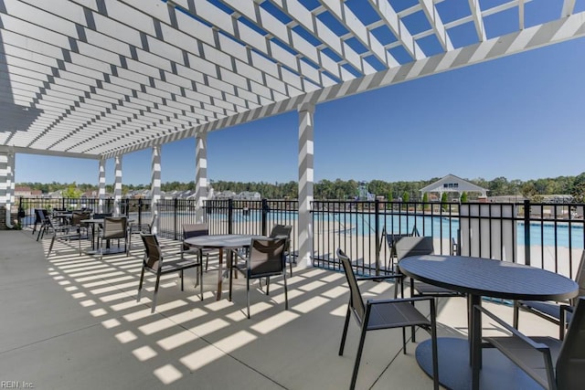 view of patio featuring a community pool and a pergola