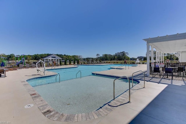 view of pool with a pergola and a patio