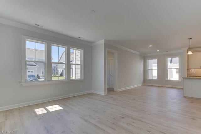 unfurnished living room with ornamental molding and light hardwood / wood-style floors