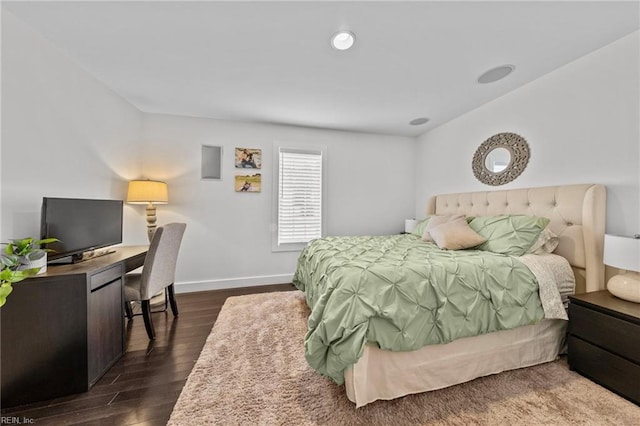 bedroom with dark hardwood / wood-style floors