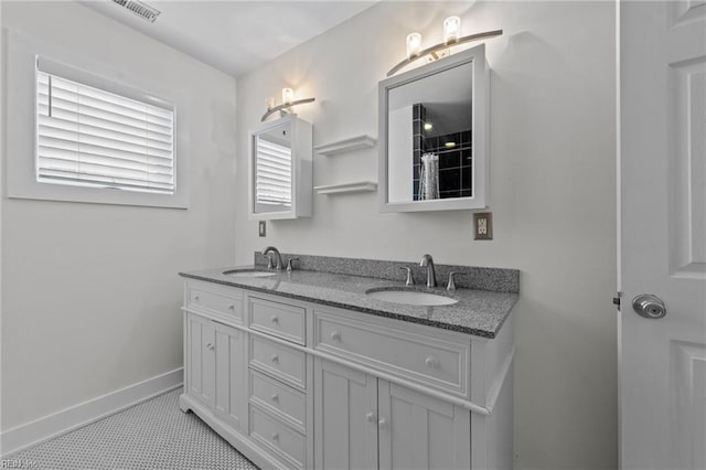 bathroom featuring tile patterned flooring and vanity