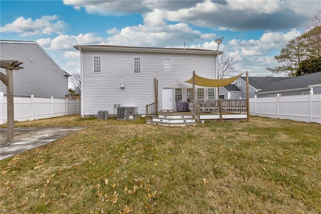 rear view of property featuring a wooden deck, a yard, and central air condition unit