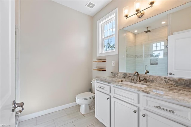 bathroom with vanity, an enclosed shower, and toilet