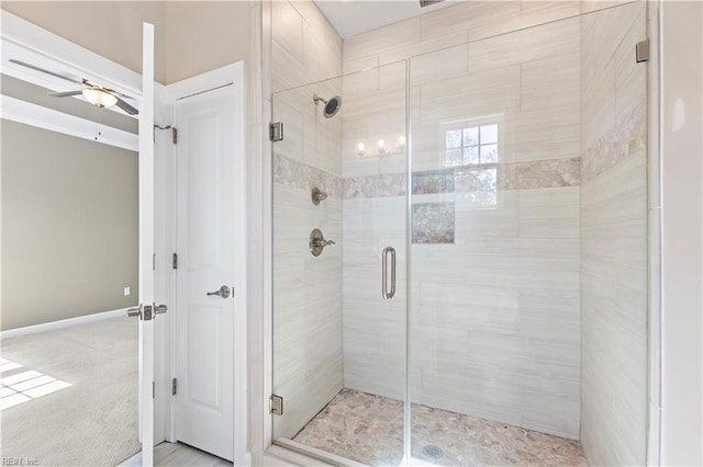 bathroom featuring ceiling fan and a shower with shower door