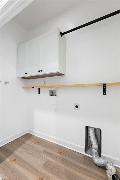 laundry area featuring cabinets, washer hookup, light hardwood / wood-style floors, and electric dryer hookup