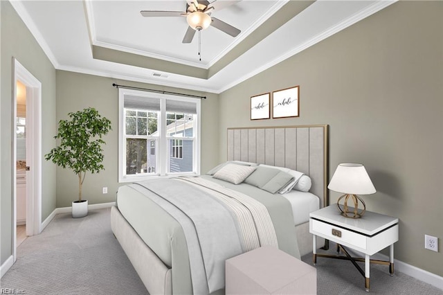 bedroom with crown molding, light colored carpet, a raised ceiling, and ceiling fan