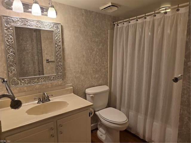 bathroom with vanity, a shower with curtain, and toilet