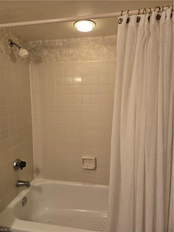 bathroom featuring shower / bathtub combination with curtain