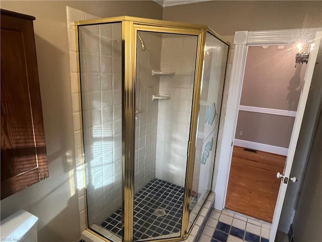 bathroom featuring an enclosed shower and tile patterned flooring