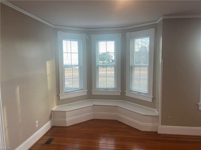 interior space featuring ornamental molding and hardwood / wood-style floors