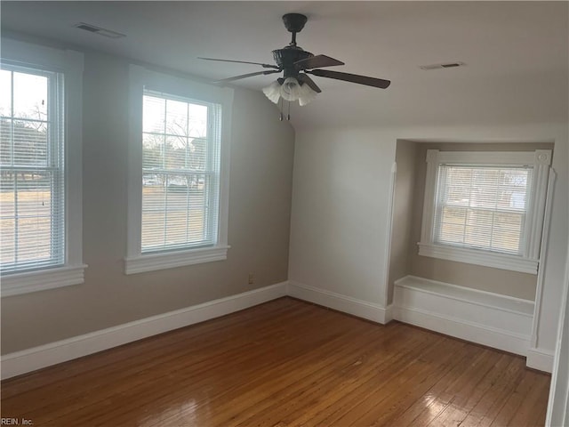 spare room featuring hardwood / wood-style flooring and ceiling fan