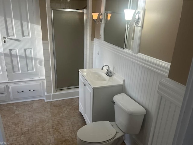 bathroom featuring vanity, toilet, and an enclosed shower