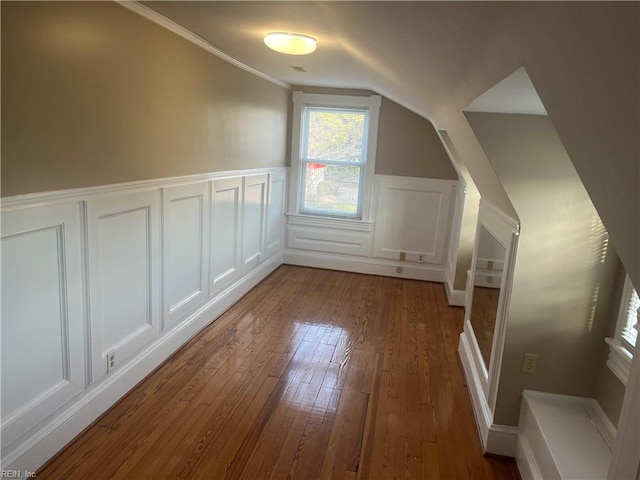 additional living space with vaulted ceiling and hardwood / wood-style floors