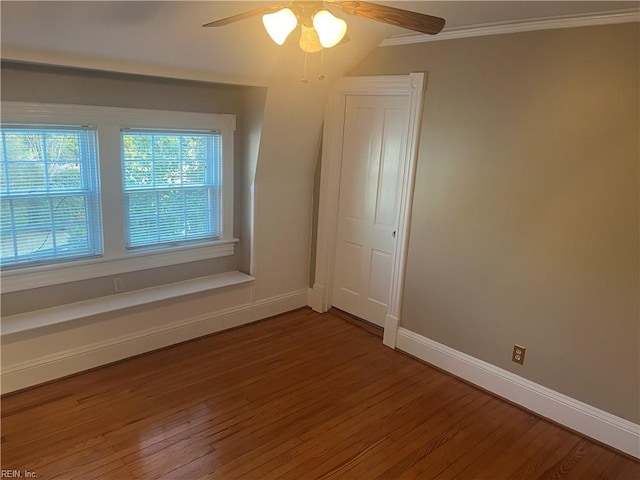 empty room with crown molding, ceiling fan, and wood-type flooring