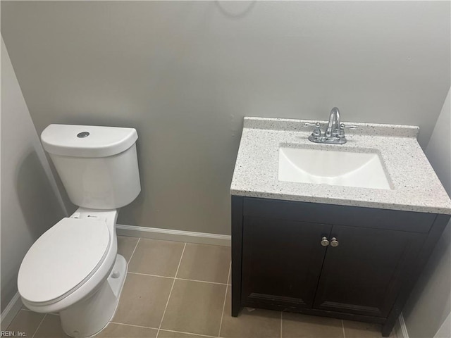 bathroom featuring tile patterned flooring, vanity, and toilet