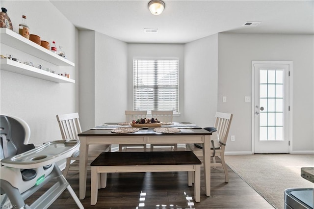 dining space with wood-type flooring