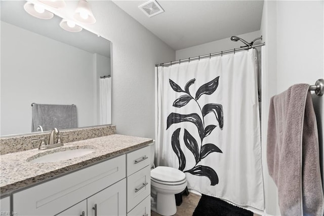 bathroom featuring vanity, a shower with curtain, and toilet