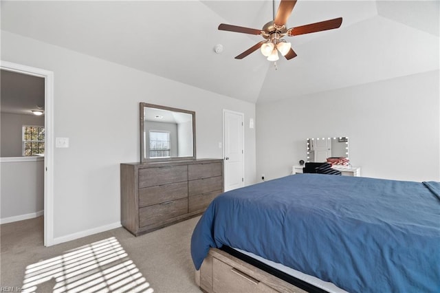 bedroom featuring vaulted ceiling, light colored carpet, and ceiling fan