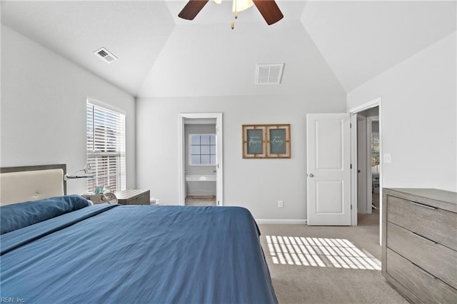 unfurnished bedroom featuring high vaulted ceiling, carpet floors, connected bathroom, and ceiling fan