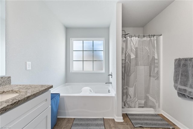 bathroom with vanity and separate shower and tub