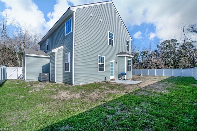 rear view of property featuring central AC unit, a lawn, and a patio area