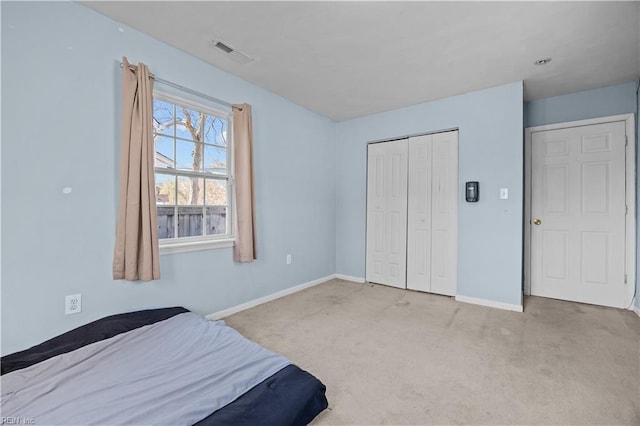 carpeted bedroom featuring a closet