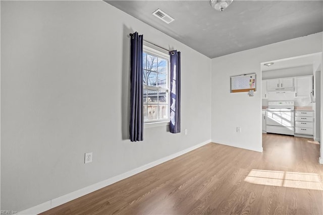 spare room featuring light hardwood / wood-style floors