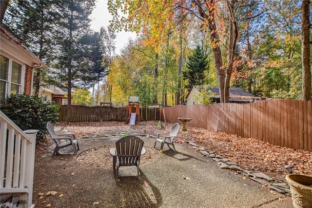 view of yard featuring a patio area and a playground